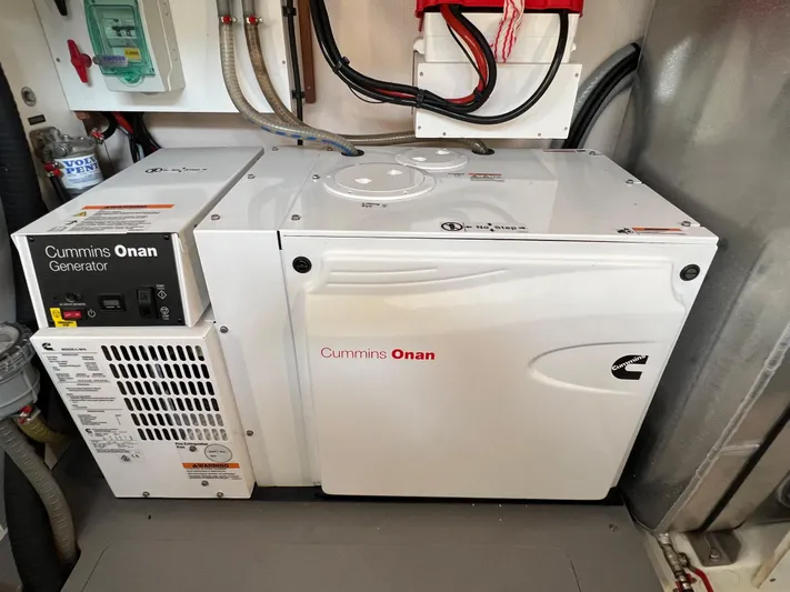 Kuramati III Yacht Photos Pics Cummins Onan generator in a 2016 Prestige 500 yacht engine room.