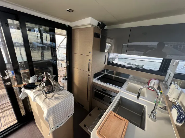 Kuramati III Yacht Photos Pics Modern kitchen interior on 2016 Prestige 500 yacht, featuring sleek cabinetry and appliances.