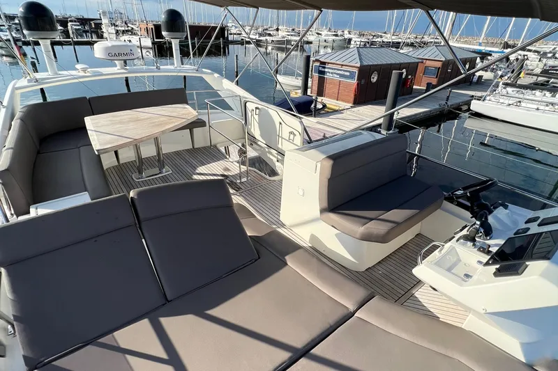 Kuramati III Yacht Photos Pics Prestige 500 yacht deck, 2016 model, featuring seating and table at marina.