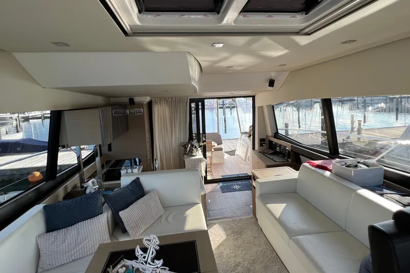 Kuramati III Yacht Photos Pics Luxurious interior of a 2016 Prestige 500 yacht with modern furnishings and marina view.