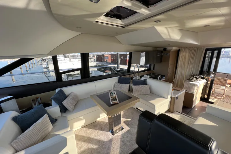 Kuramati III Yacht Photos Pics Luxurious interior of a 2016 Prestige 500 yacht with elegant seating and panoramic windows.