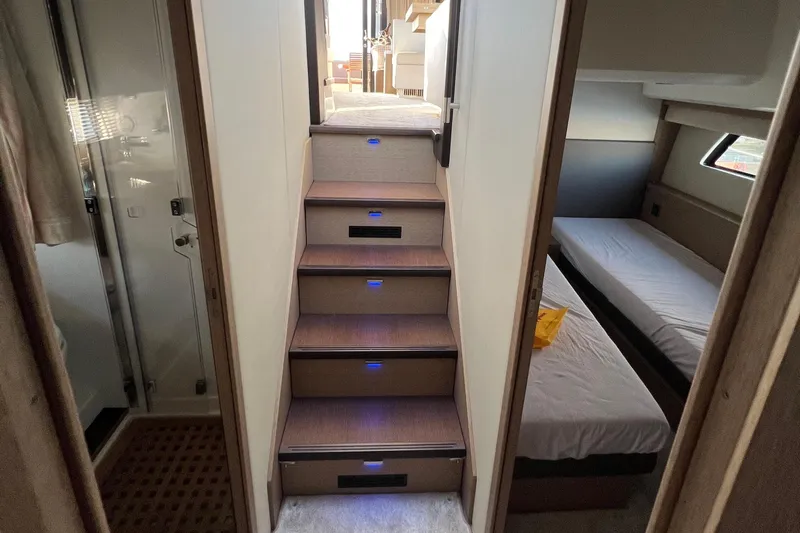 Kuramati III Yacht Photos Pics Interior of a 2016 Prestige 500 yacht with illuminated stairs and cozy cabins.