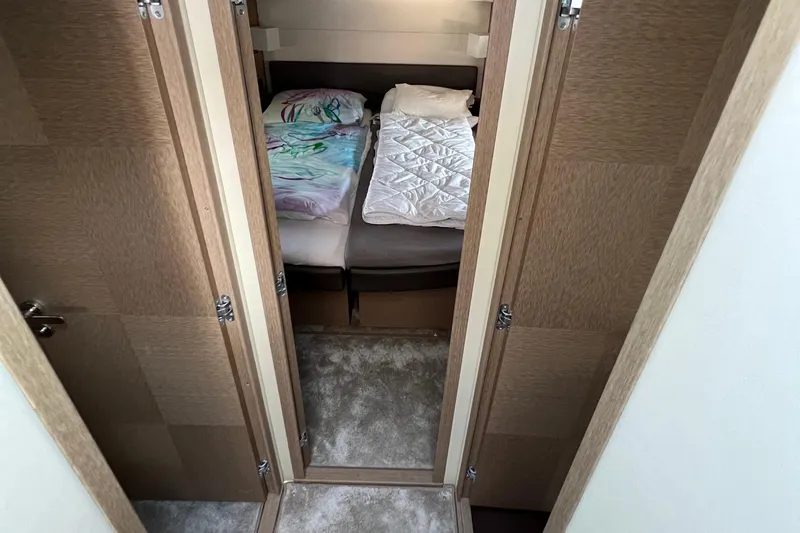 Kuramati III Yacht Photos Pics Luxurious cabin interior of a 2016 Prestige 500 yacht with twin beds.