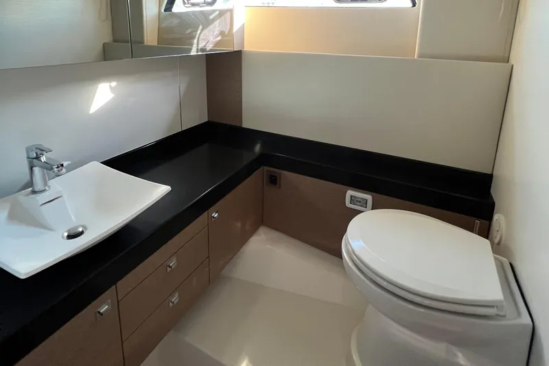 Kuramati III Yacht Photos Pics Modern bathroom in a 2016 Prestige 500 yacht with sleek sink and toilet.