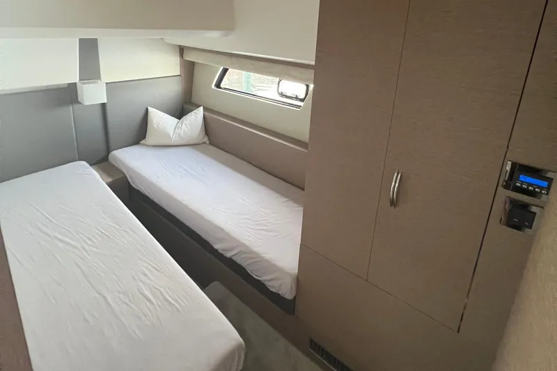 Kuramati III Yacht Photos Pics Twin cabin interior of 2016 Prestige 500 yacht with modern design and compact storage.