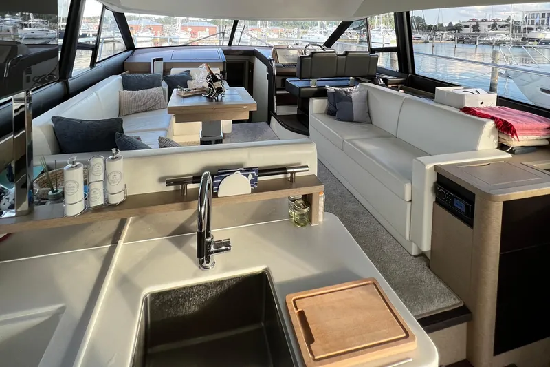 Kuramati III Yacht Photos Pics Luxurious interior of a 2016 Prestige 500 yacht with modern furnishings and spacious seating.