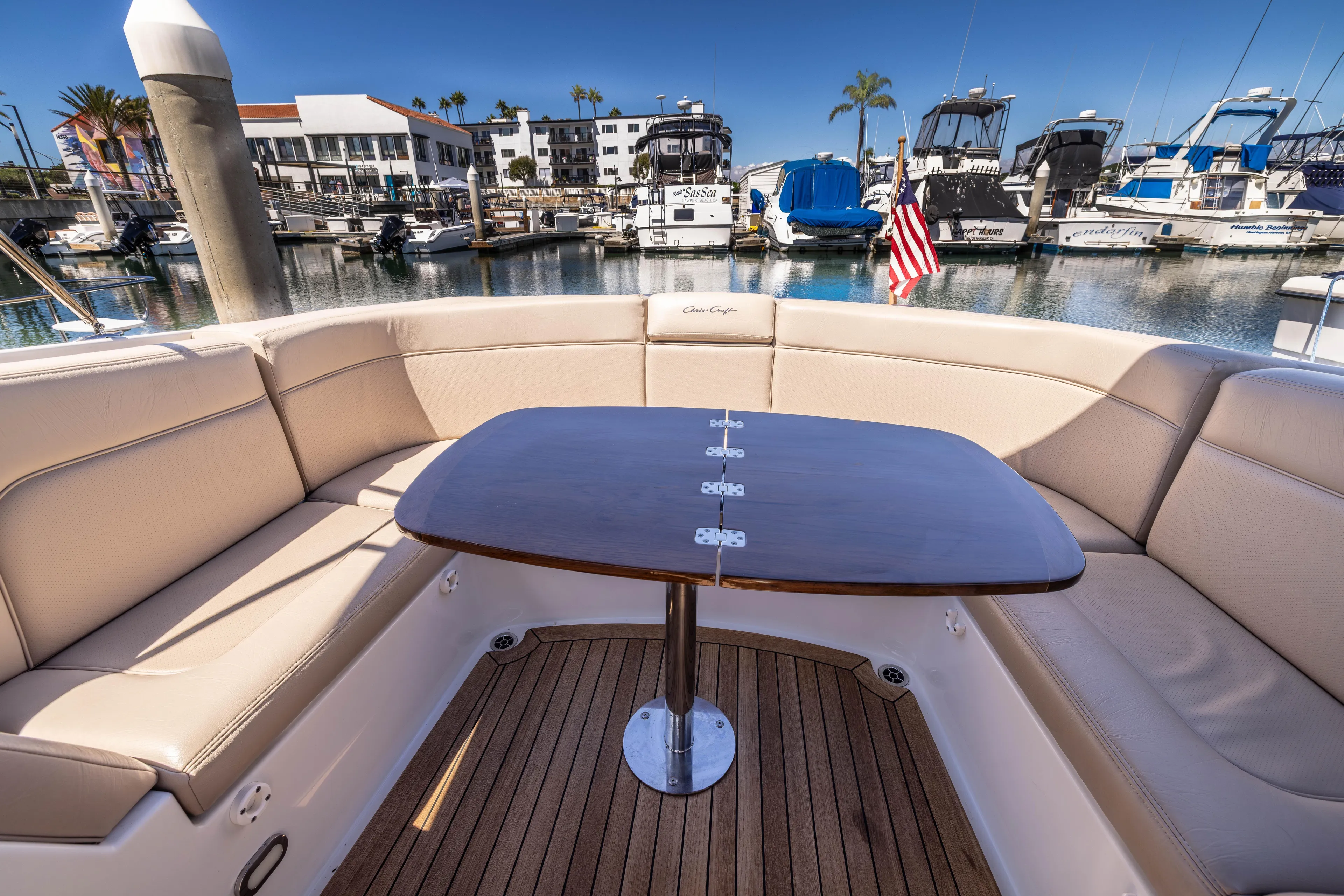 Zingaro Yacht Photos Pics 2007 Chris Craft Corsair boat interior with elegant seating and wooden table at marina.