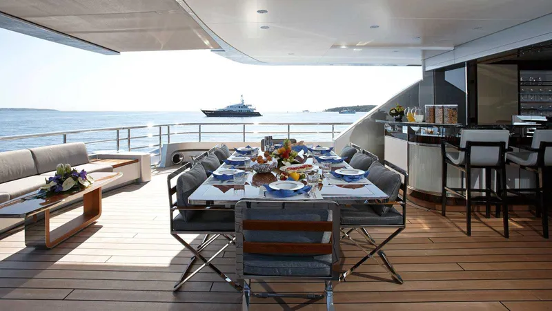 Excellence V Yacht Photos Pics Luxurious dining area on Feadship EXCELLENCE V yacht, 2014, with ocean view and elegant table setting.