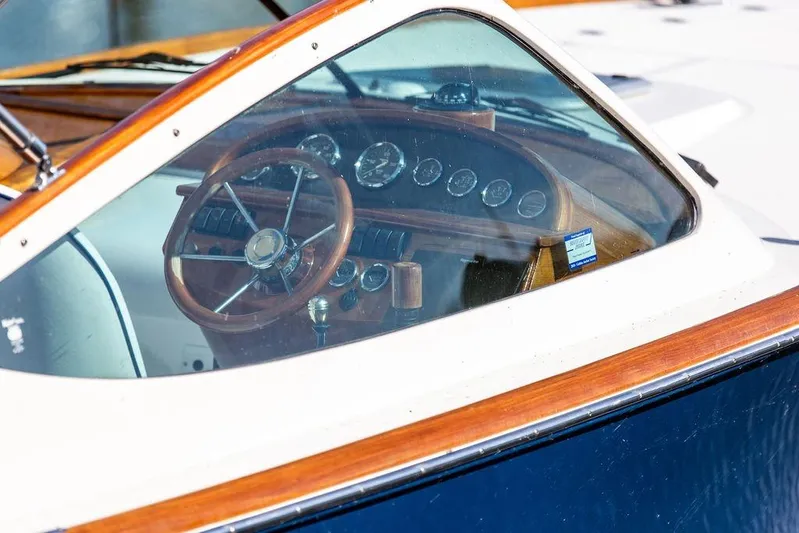 Firefly Yacht Photos Pics Interior view of 2003 Hinckley T29R boat, showcasing wooden steering wheel and dashboard.