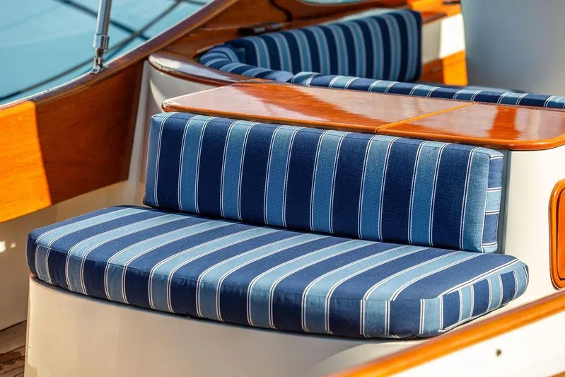 Firefly Yacht Photos Pics Blue striped seating on 2003 Hinckley T29R boat with polished wood accents.
