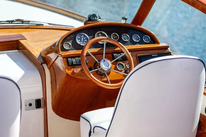 Firefly Yacht Photos Pics 2003 Hinckley T29R boat helm with wooden dashboard and steering wheel.