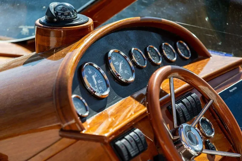 Firefly Yacht Photos Pics Hinckley T29R 2003 boat dashboard with wooden steering wheel and gauges.
