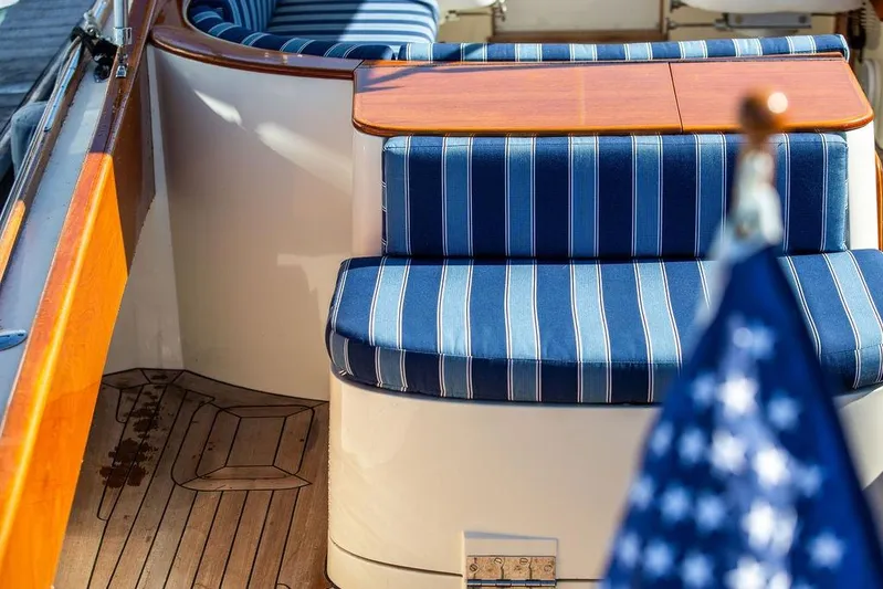 Firefly Yacht Photos Pics Hinckley T29R 2003 boat interior with striped blue seating and wooden accents.