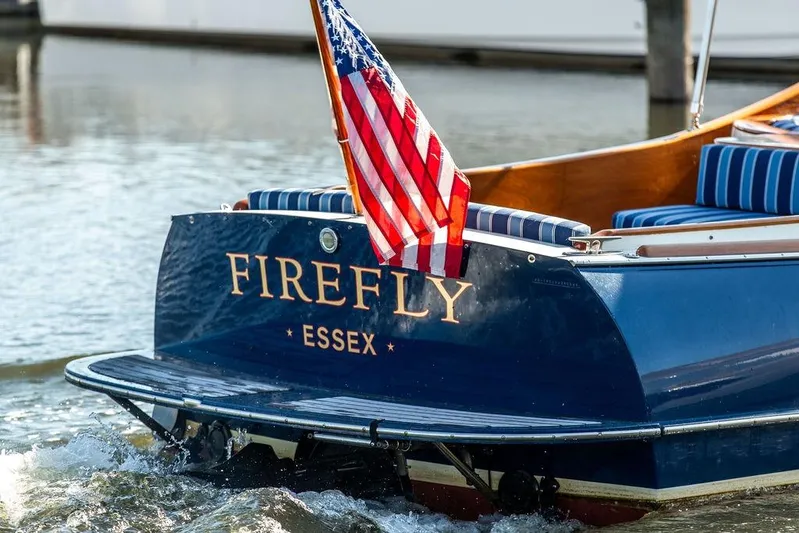 Firefly Yacht Photos Pics Hinckley T29R 2003 boat "Firefly" with American flag, Essex location, on water.