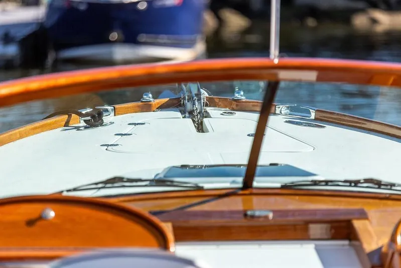 Firefly Yacht Photos Pics Close-up of 2003 Hinckley T29R boat dashboard with wooden trim and clear windshield.