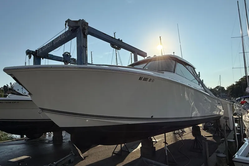  Yacht Photos Pics 2019 Pursuit DC 325 Dual Console boat on dry dock under a clear sky.