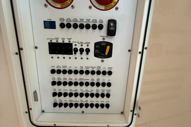  Yacht Photos Pics Control panel of a 2019 Pursuit DC 325 Dual Console boat with various switches and indicators.