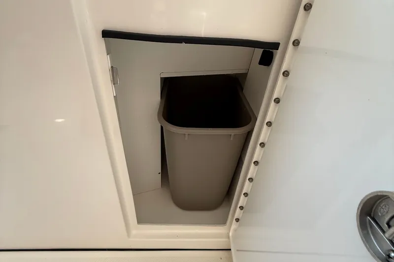  Yacht Photos Pics Storage compartment with trash bin on 2019 Pursuit DC 325 Dual Console boat.