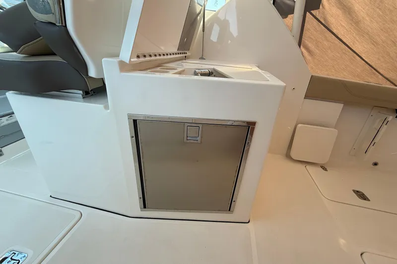  Yacht Photos Pics 2019 Pursuit DC 325 Dual Console interior with storage compartment and seating.