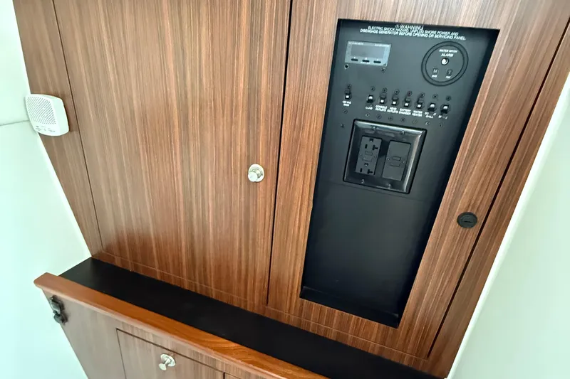  Yacht Photos Pics 2019 Pursuit DC 325 Dual Console control panel with wood finish and electrical switches.