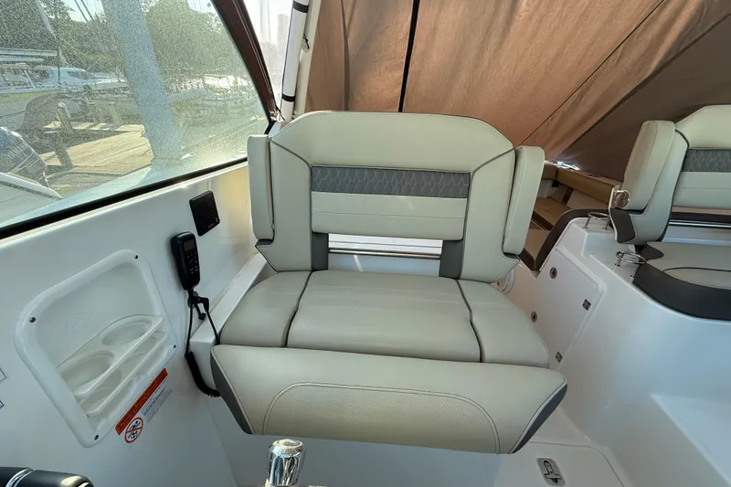  Yacht Photos Pics 2019 Pursuit DC 325 Dual Console boat interior with cushioned seating and cup holders.