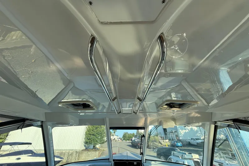  Yacht Photos Pics 2019 Pursuit DC 325 Dual Console interior ceiling with stainless steel handrails.