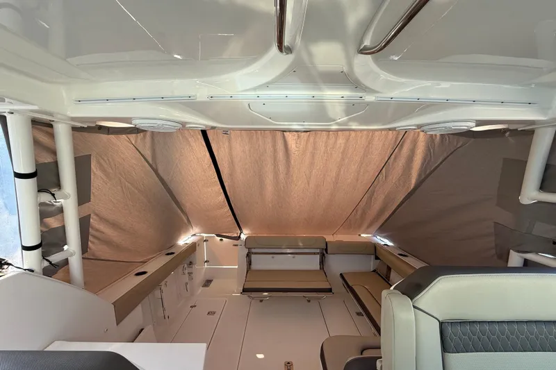  Yacht Photos Pics 2019 Pursuit DC 325 Dual Console interior with seating and protective cover.