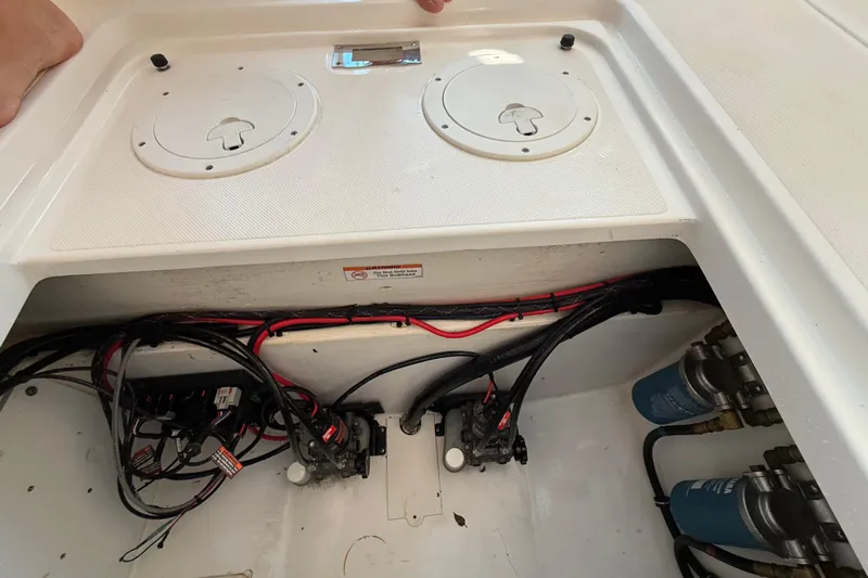  Yacht Photos Pics 2019 Pursuit DC 325 Dual Console boat wiring and components in storage compartment.
