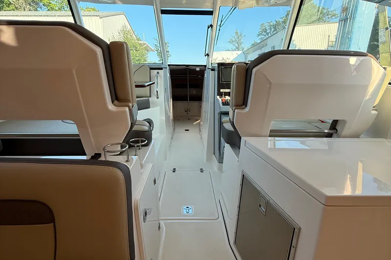  Yacht Photos Pics 2019 Pursuit DC 325 Dual Console interior with seating and console view.