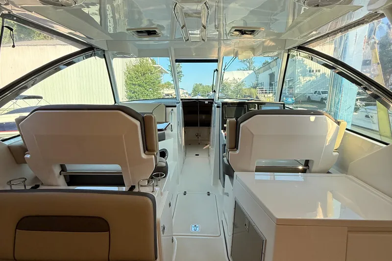  Yacht Photos Pics 2019 Pursuit DC 325 Dual Console interior with modern seating and navigation area.