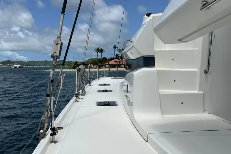 Dignity Yacht Photos Pics 2021 Lagoon 50 catamaran deck with ocean view and tropical background.