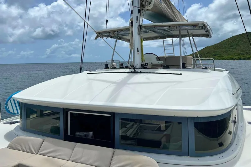 Dignity Yacht Photos Pics 2021 Lagoon 50 catamaran on calm waters with scenic island backdrop.