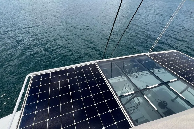 Dignity Yacht Photos Pics Solar panels on 2021 Lagoon 50 catamaran, overlooking calm ocean waters.