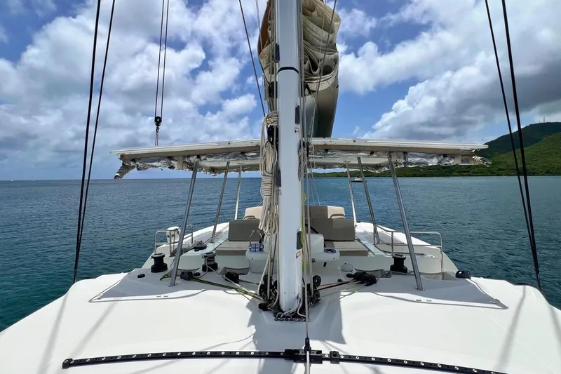 Dignity Yacht Photos Pics Lagoon 50 catamaran sailing on calm waters under a partly cloudy sky, 2021 model.