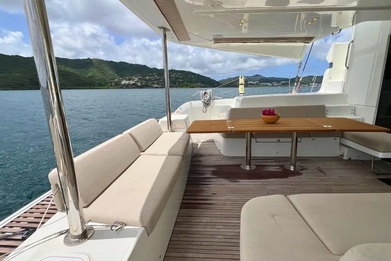 Dignity Yacht Photos Pics Spacious deck of 2021 Lagoon 50 yacht with seating and scenic ocean view.