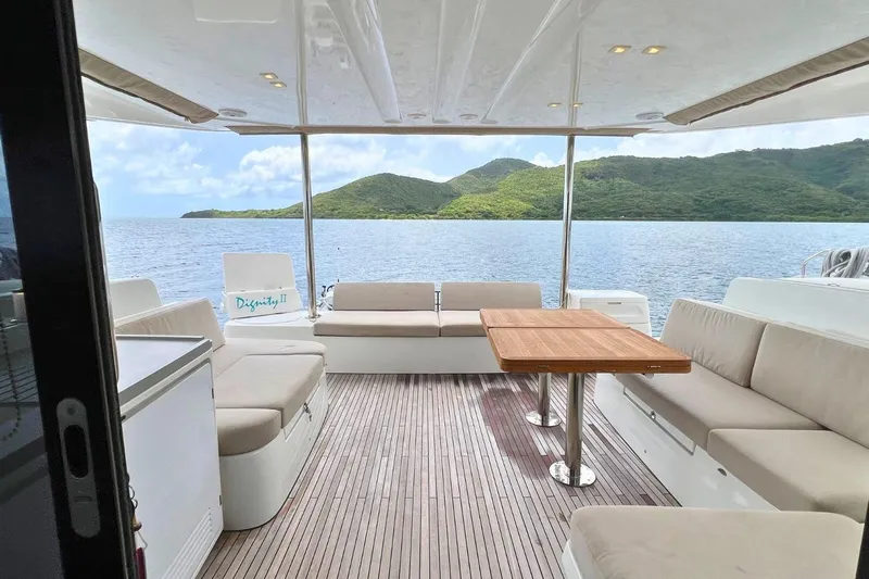 Dignity Yacht Photos Pics Luxurious Lagoon 50 yacht interior with seating, table, and scenic ocean view, 2021 model.