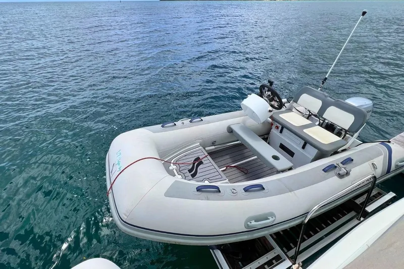 Dignity Yacht Photos Pics Inflatable dinghy on water, attached to Lagoon 50 yacht, 2021 model.