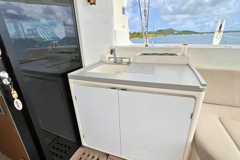 Dignity Yacht Photos Pics Outdoor kitchenette on a 2021 Lagoon 50 catamaran with ocean view.