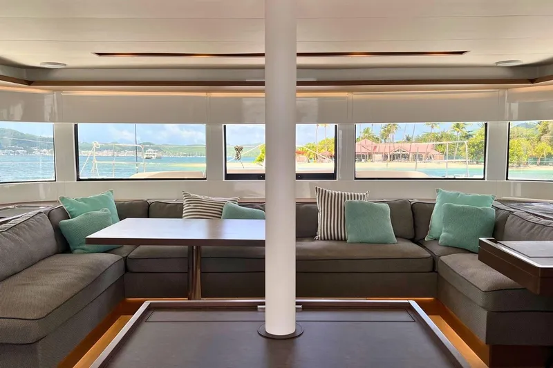 Dignity Yacht Photos Pics Luxurious interior of 2021 Lagoon 50 yacht with panoramic windows and plush seating.