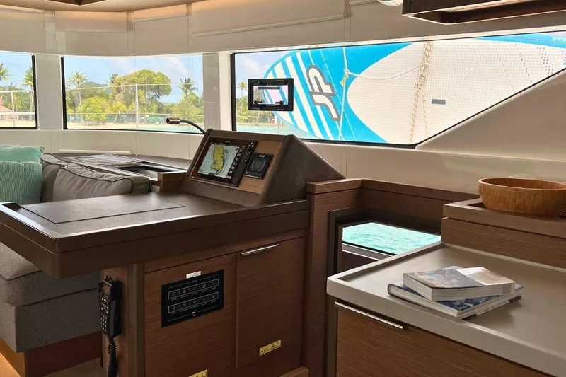 Dignity Yacht Photos Pics Interior of 2021 Lagoon 50 yacht with navigation station and scenic window view.