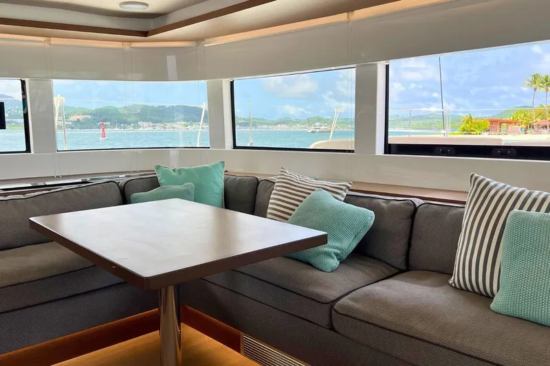 Dignity Yacht Photos Pics Interior of 2021 Lagoon 50 yacht with cozy seating and ocean view.