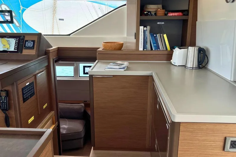 Dignity Yacht Photos Pics Interior of 2021 Lagoon 50 yacht with modern kitchen and navigation area.