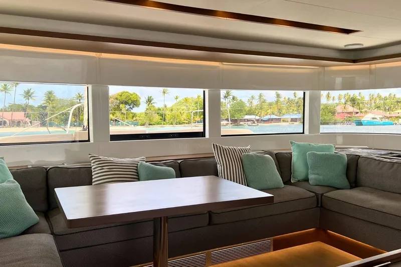 Dignity Yacht Photos Pics Luxurious interior of 2021 Lagoon 50 yacht with scenic ocean view through large windows.