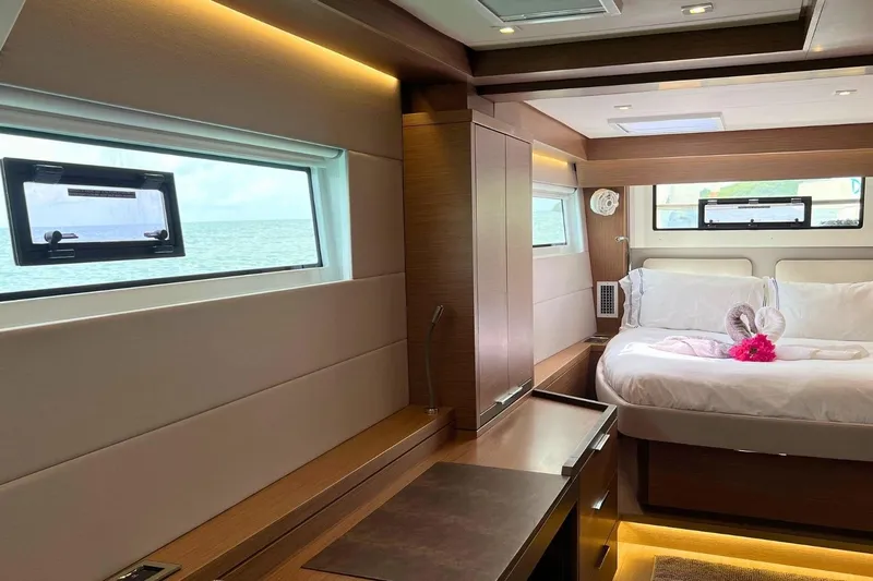 Dignity Yacht Photos Pics Luxurious interior of 2021 Lagoon 50 yacht with elegant bedroom and ocean view.
