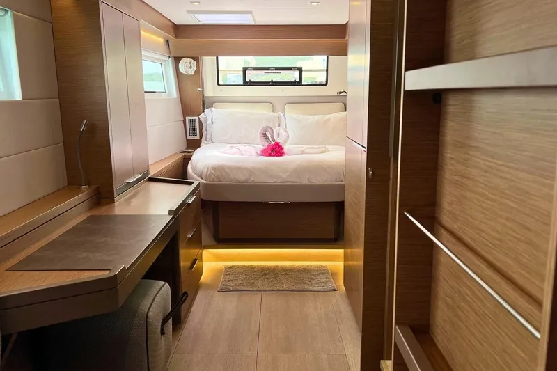 Dignity Yacht Photos Pics Luxurious interior of 2021 Lagoon 50 yacht with cozy bedroom and elegant wood finishes.
