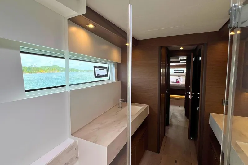 Dignity Yacht Photos Pics Luxurious interior of 2021 Lagoon 50 yacht with modern bathroom and scenic window view.