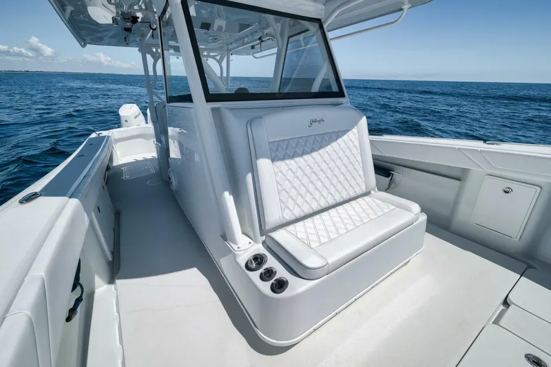  Yacht Photos Pics 2023 Yellowfin 39 Offshore boat interior with white seating, on open ocean.