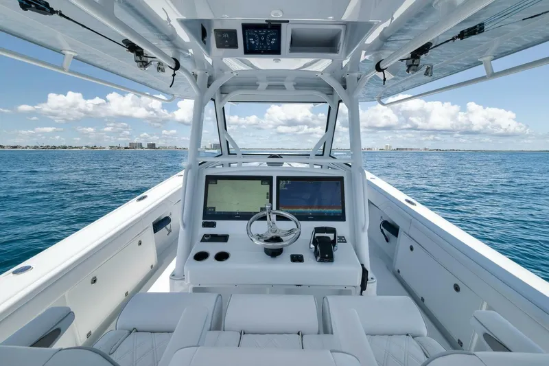  Yacht Photos Pics 2023 Yellowfin 39 Offshore boat interior with advanced navigation system on open sea.