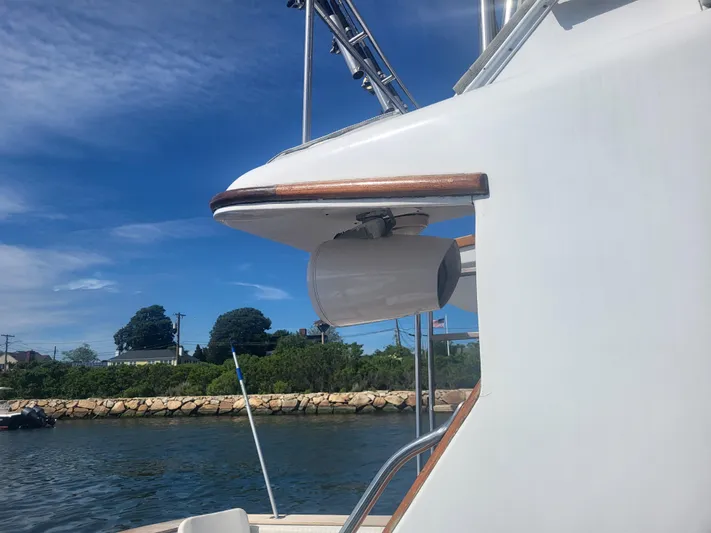Hailey Girl Yacht Photos Pics 1989 Ocean Yachts 48 boat detail with clear sky and shoreline background.