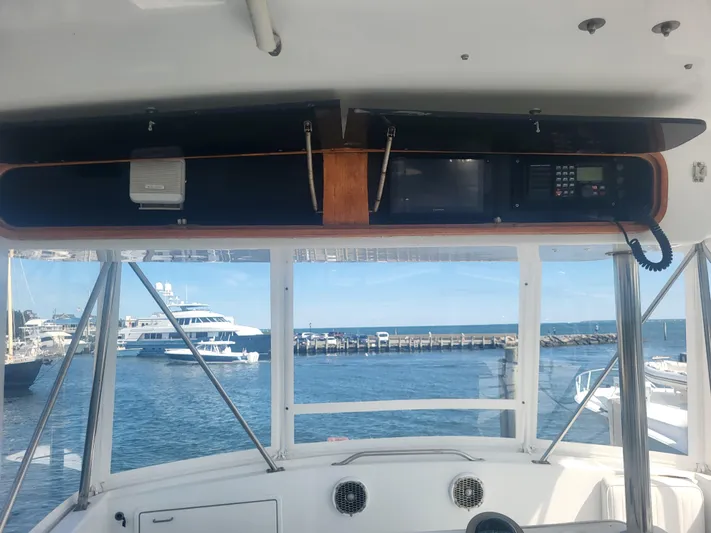 Hailey Girl Yacht Photos Pics Interior view of 1989 Ocean Yachts 48, featuring navigation equipment and ocean backdrop.